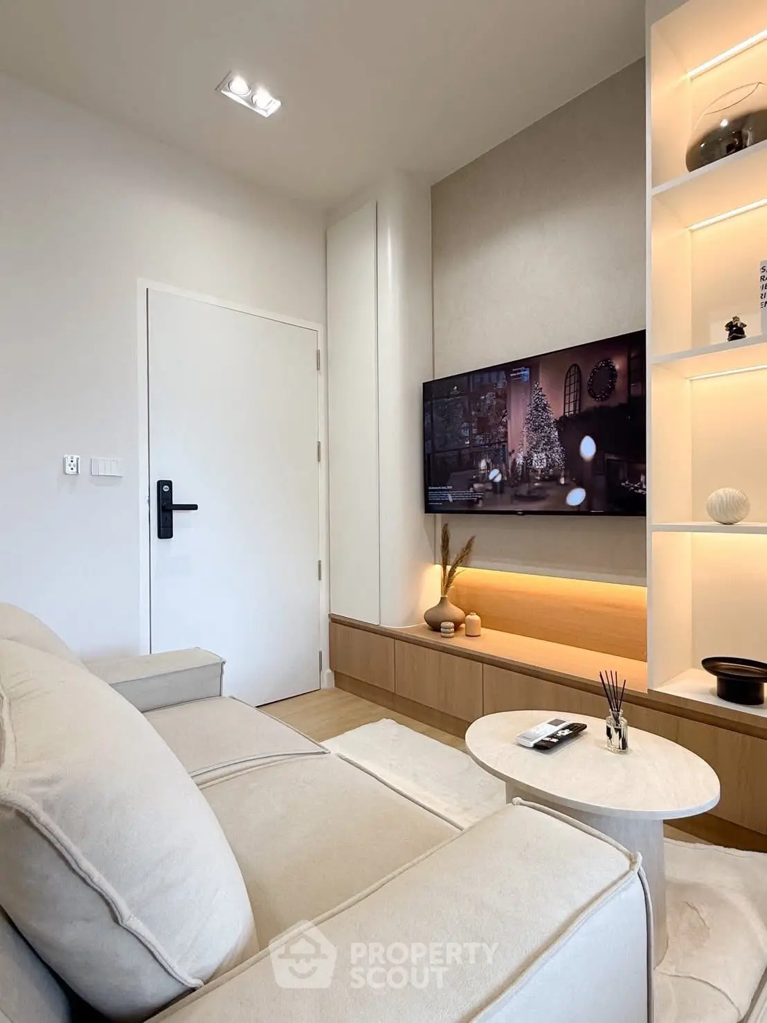 Modern living room with sleek design, cozy sofa, and wall-mounted TV for ultimate comfort and style.
