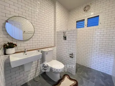 Modern bathroom with white subway tiles and sleek fixtures