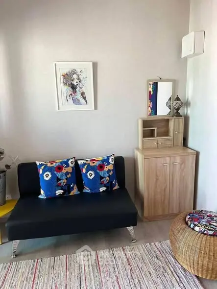 Charming living room with modern decor and colorful accents, perfect for cozy relaxation.