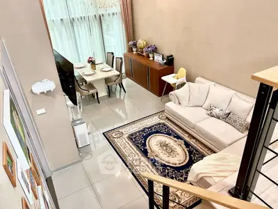 Spacious modern living room with elegant decor and dining area, featuring large windows and stylish furniture.