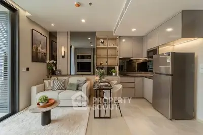 Modern open-layout living room and kitchen with sleek design and cozy ambiance.