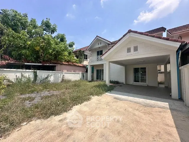 Charming suburban house with spacious driveway and lush greenery, perfect for family living.
