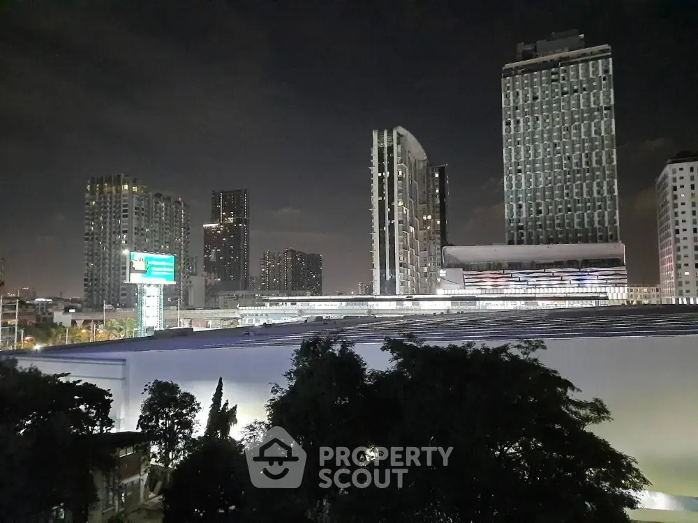 Stunning night cityscape view with modern high-rise buildings and illuminated skyline.