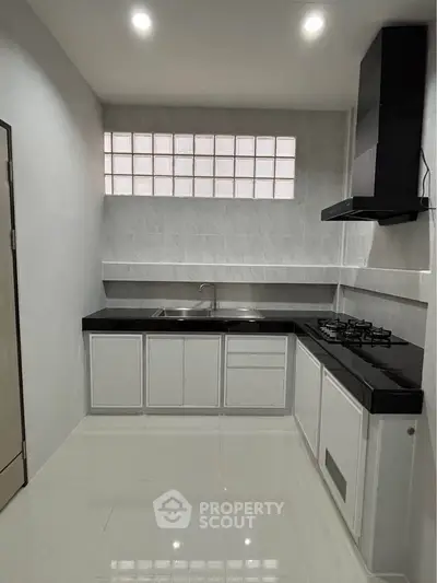 Modern kitchen with sleek black countertops and gas stove