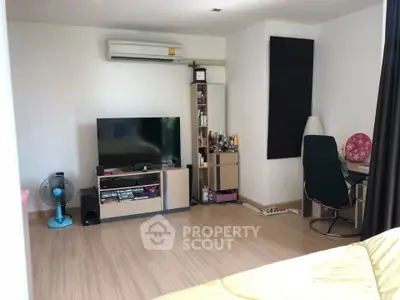 Spacious living room with modern decor and entertainment setup