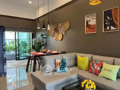 Stylish living room with modern decor, vibrant cushions, and elegant dining area, perfect for entertaining.