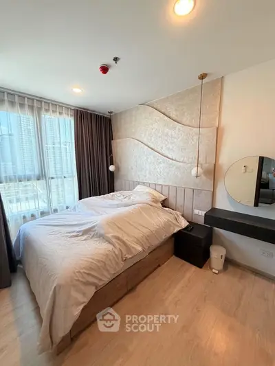 Modern bedroom with stylish decor and city view, featuring a cozy bed and elegant lighting.
