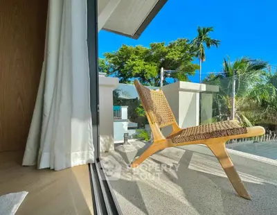 Stunning balcony view with modern chair and lush greenery, perfect for relaxation.