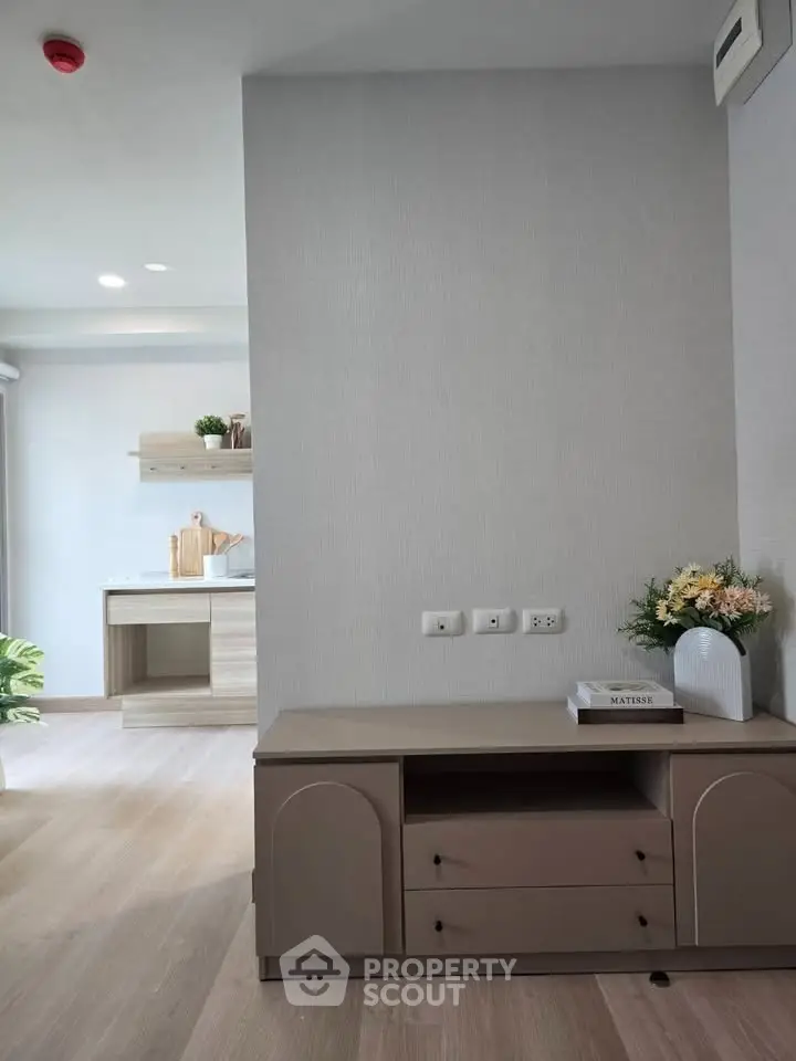 Modern living room with sleek furniture and open kitchen layout, perfect for contemporary living.