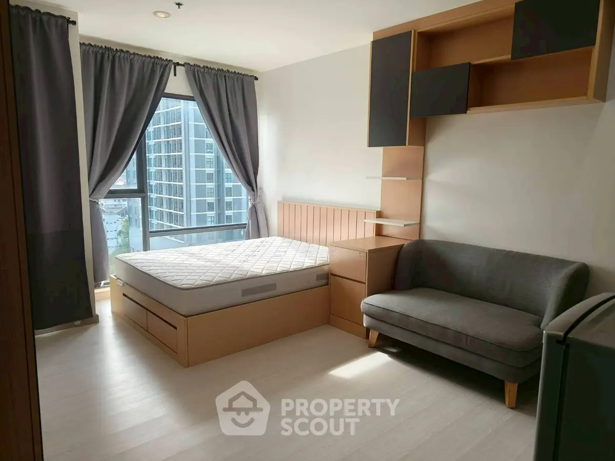 Modern bedroom with large window and stylish furniture in high-rise building