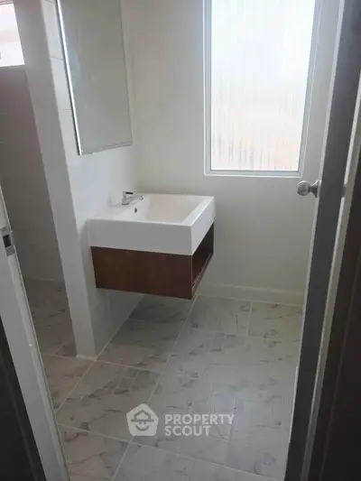 Modern bathroom with sleek sink and large window for natural light