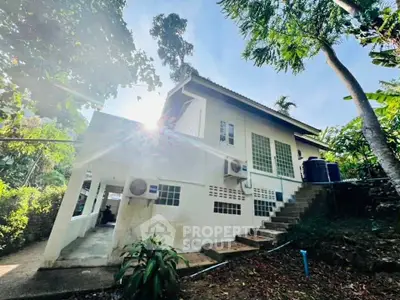 Charming hillside home with lush greenery and modern amenities