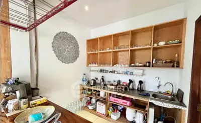 Charming kitchen with open shelving and modern appliances, perfect for culinary enthusiasts.