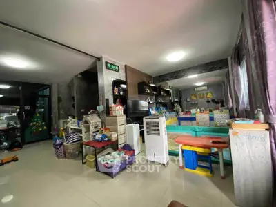 Spacious living room with modern decor and ample natural light, perfect for family gatherings.