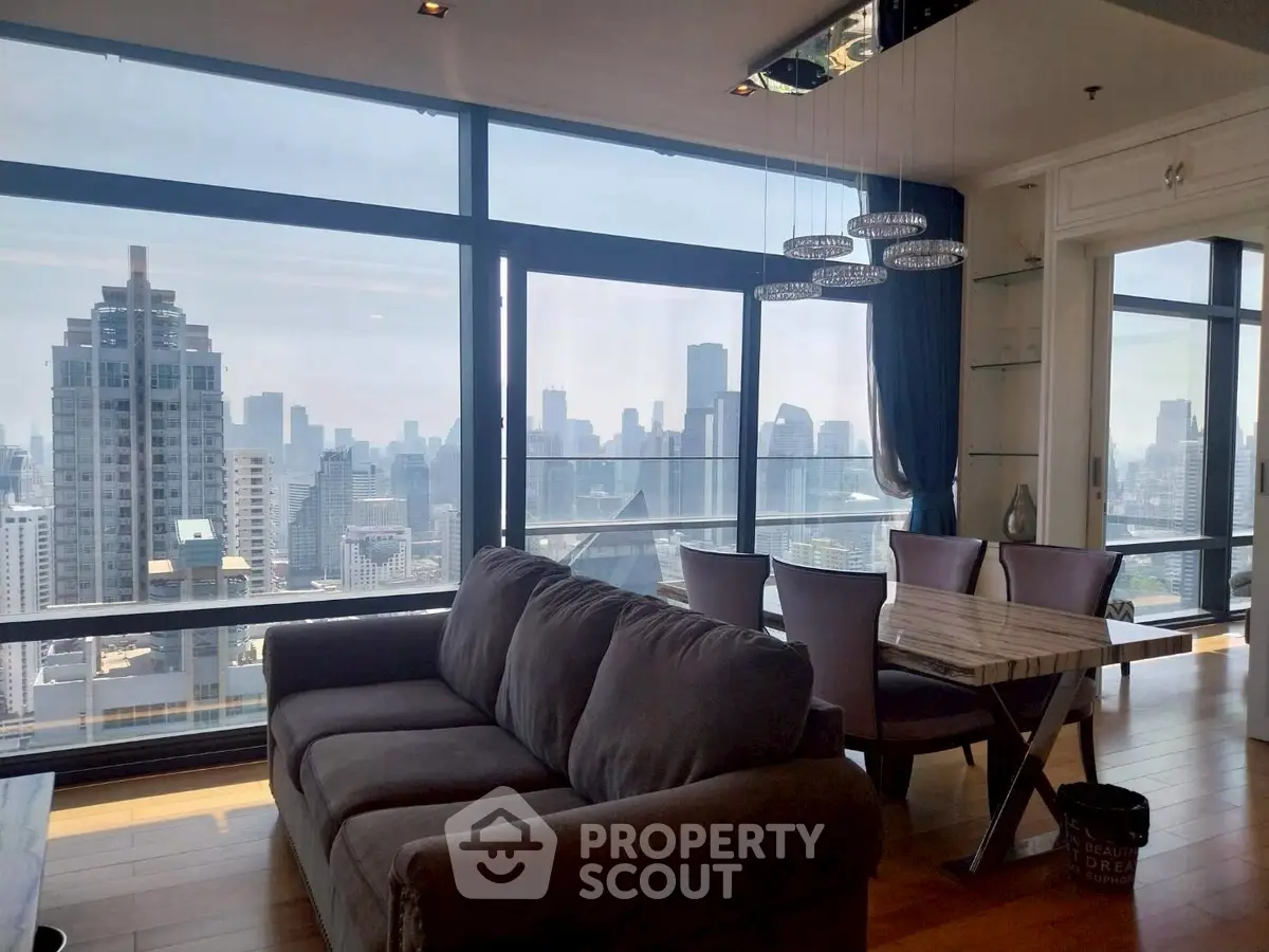 Luxurious living room with stunning city skyline view and modern furnishings.