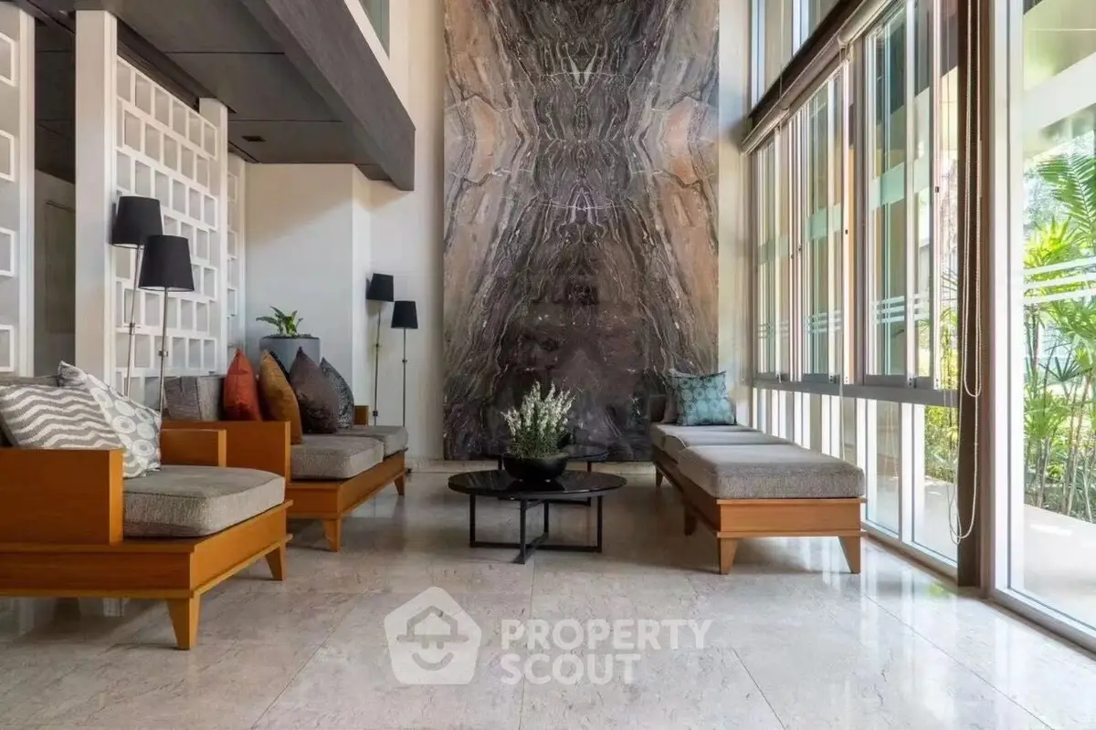 Luxurious modern living room with elegant decor and large windows offering natural light.
