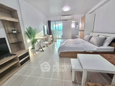 Modern studio apartment with balcony and stylish furnishings, perfect for urban living.
