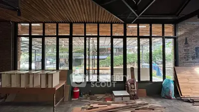 Spacious under-construction room with large windows and wooden ceiling