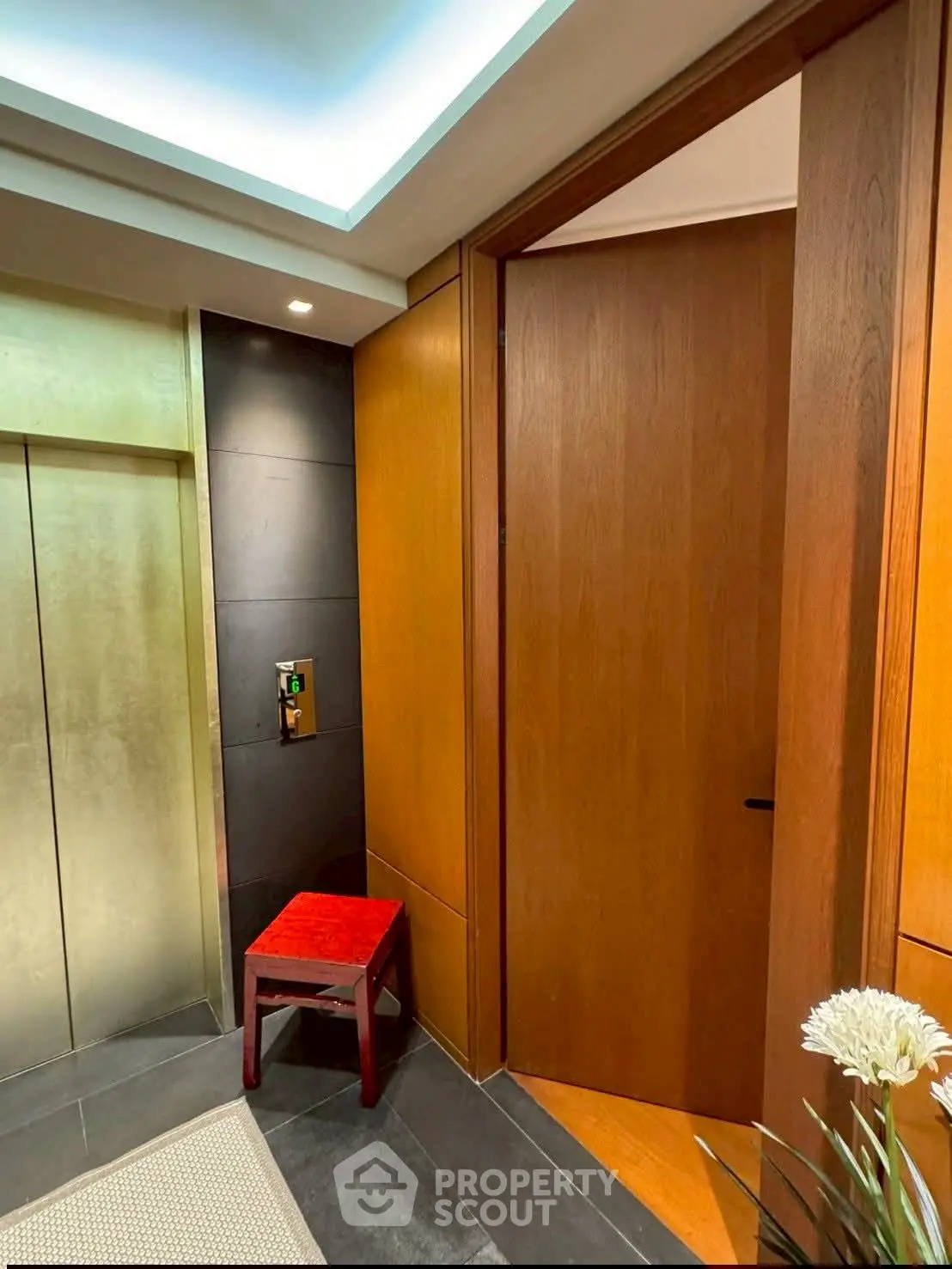 Luxurious elevator entrance with elegant wood paneling and modern lighting
