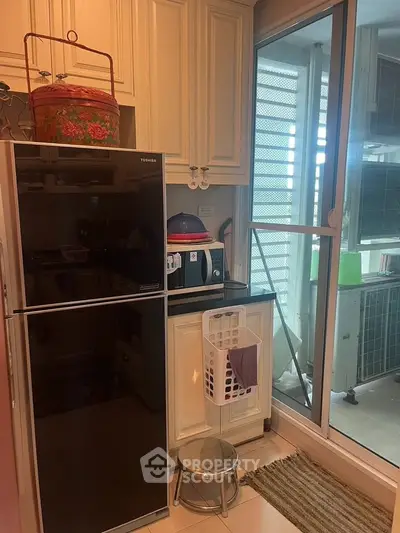 Modern kitchen with sleek appliances and balcony access