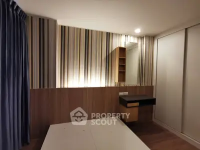 Modern bedroom with stylish striped wallpaper and built-in vanity
