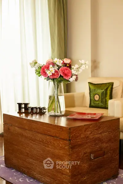 Charming living room with elegant wooden coffee table and vibrant floral arrangement.