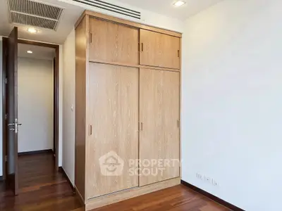 Spacious bedroom with wooden wardrobe and modern design