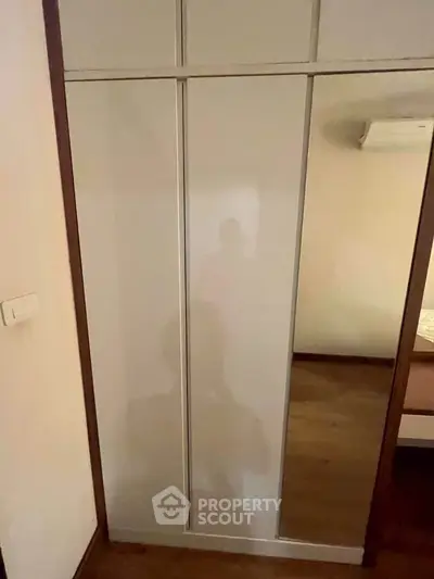 Spacious bedroom with built-in wardrobe and air conditioning unit
