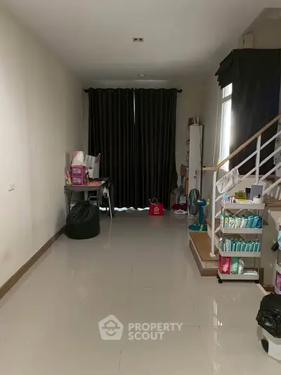 Spacious interior with sleek staircase and ample storage space, ideal for modern living.