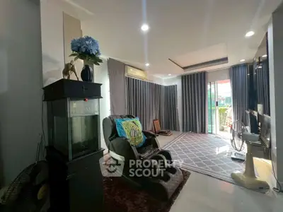 Spacious living room with modern decor and balcony access.