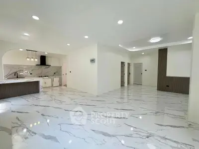 Spacious modern living room with marble flooring and open kitchen layout