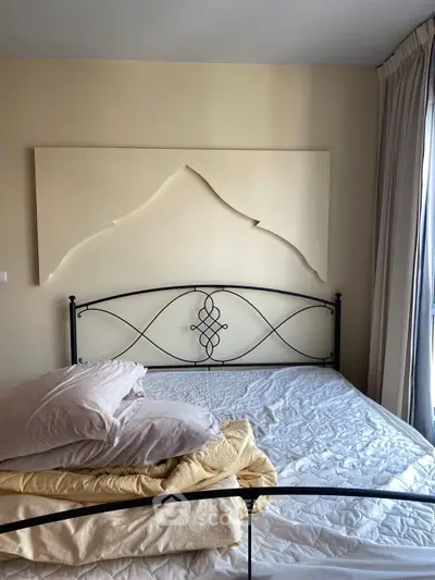 Cozy bedroom with artistic wall decor and natural light