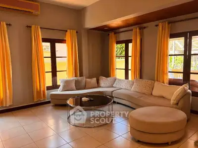 Spacious living room with stylish furniture and large windows for natural light.