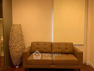 Cozy living room with stylish brown sofa and unique floor lamp