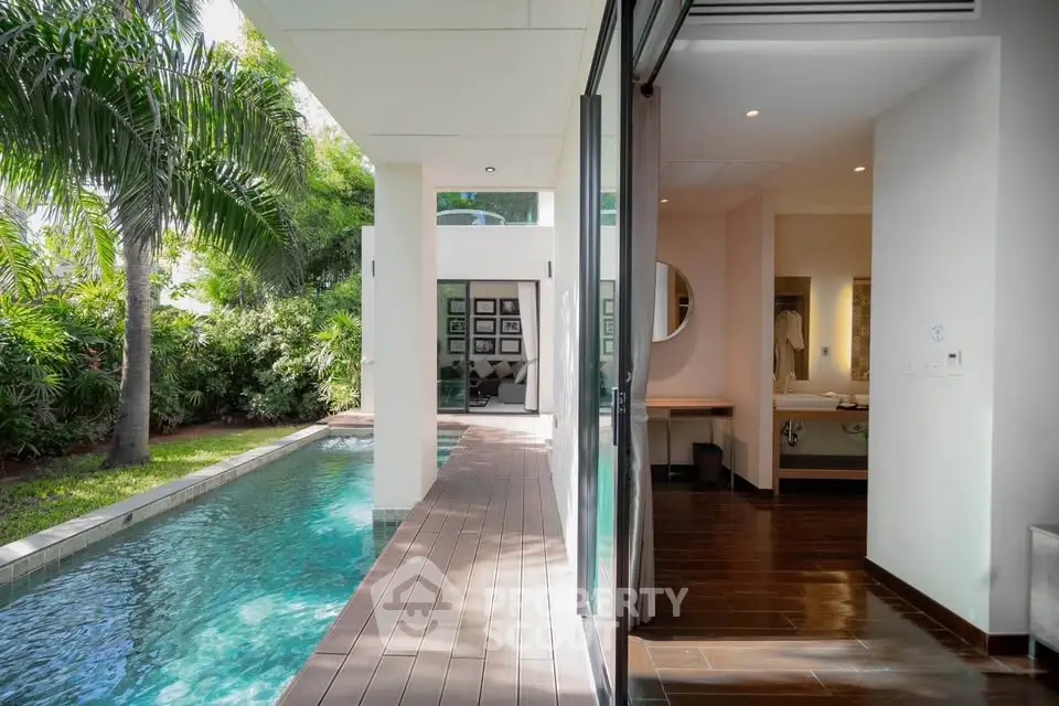 Luxurious modern home with private pool and lush garden view, perfect for serene living.