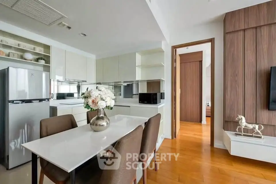 Modern kitchen and dining area with sleek design and wooden flooring