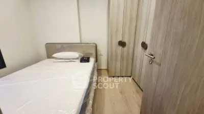 Cozy bedroom with single bed and modern wardrobe in minimalist design.