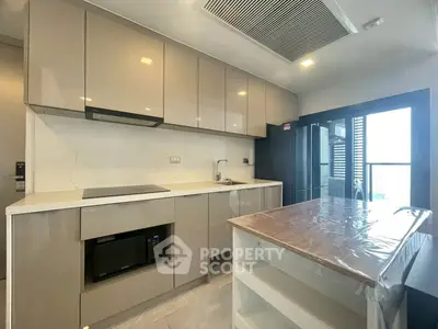 Modern kitchen with sleek cabinetry and island in contemporary apartment