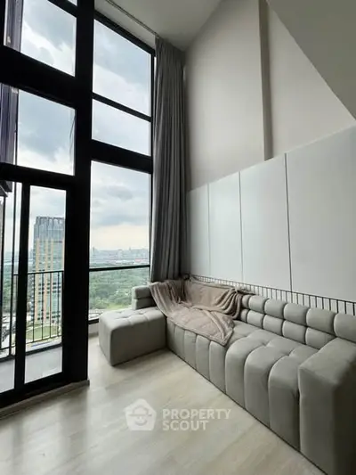 Modern living room with floor-to-ceiling windows and stunning city view