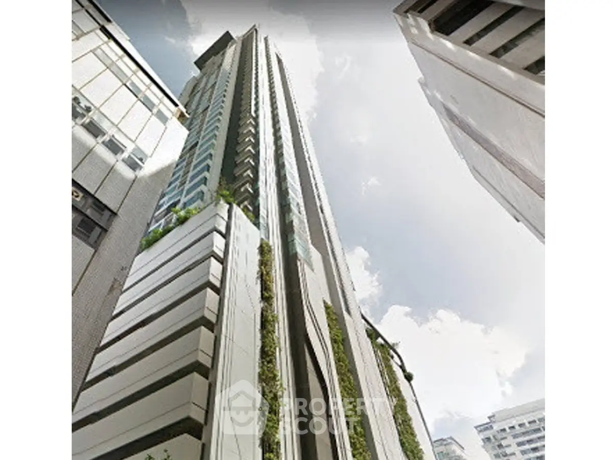 Stunning modern high-rise building with sleek architectural design in urban setting.