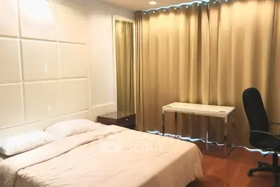Spacious bedroom with modern decor and natural light