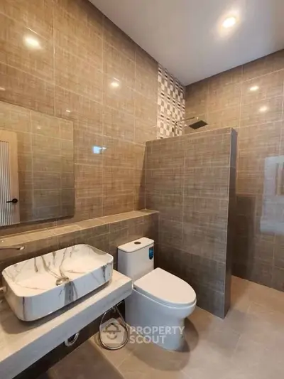 Modern bathroom with stylish marble sink and elegant tile design.
