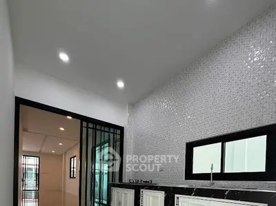Modern kitchen with sleek design and stylish backsplash in a contemporary home.