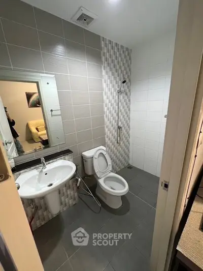 Modern bathroom with sleek fixtures and stylish tile design in a contemporary apartment.