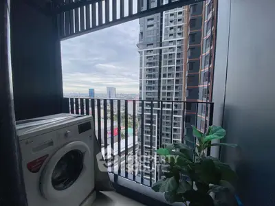 Modern balcony with washing machine and city view in high-rise apartment