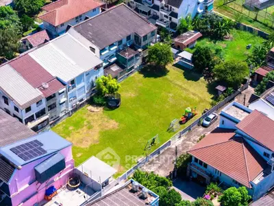Aerial view of residential area with spacious green lawn and playground.