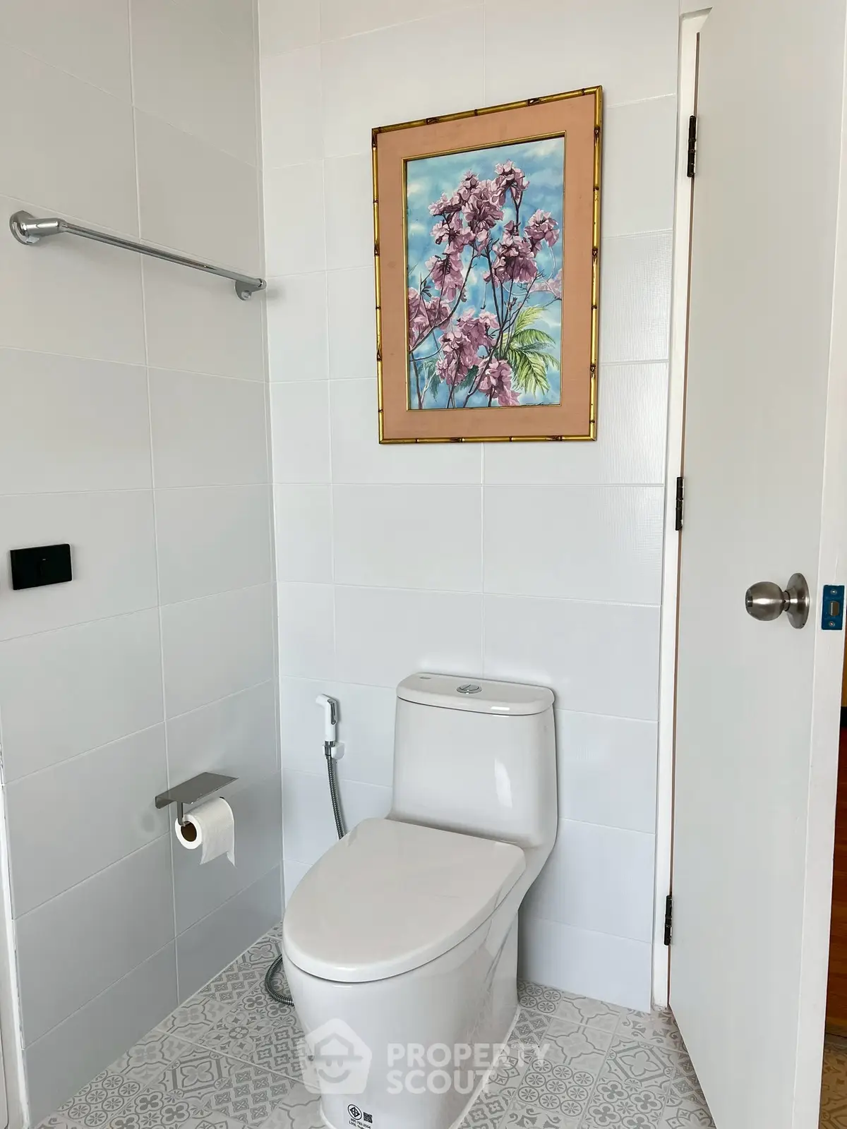 Modern bathroom with elegant painting and sleek white fixtures