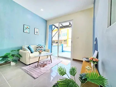 Bright and airy living room with modern decor and large glass doors leading to a sunny patio.