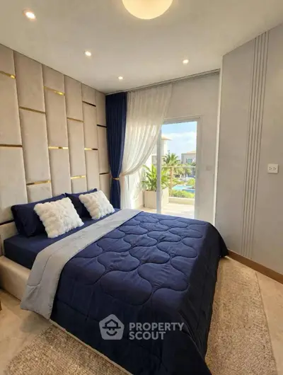 Luxurious bedroom with elegant decor and balcony view in modern real estate property.