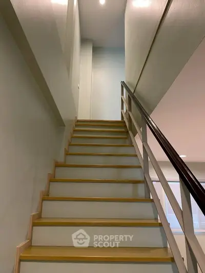 Modern staircase with sleek design and wooden steps in a contemporary home interior.